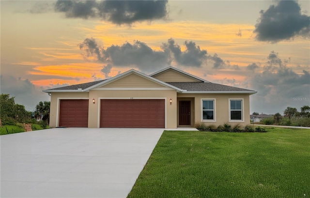 view of front of property with a lawn and a garage