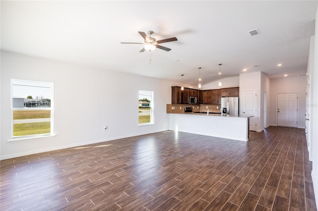 unfurnished living room featuring dark hardwood / wood-style floors and ceiling fan