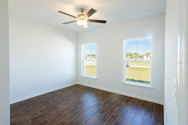 spare room featuring ceiling fan and dark wood-type flooring