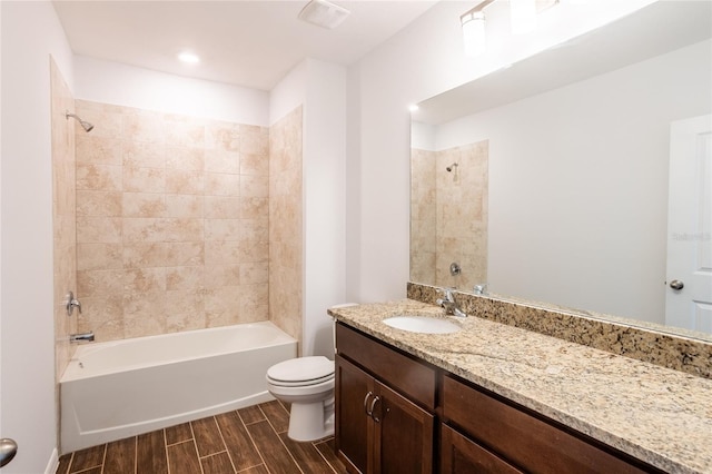 full bathroom with vanity, toilet, and tiled shower / bath