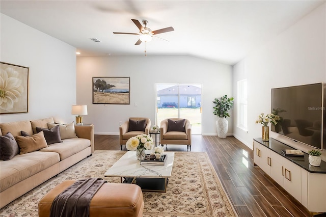 living room with ceiling fan, dark wood-type flooring, and lofted ceiling