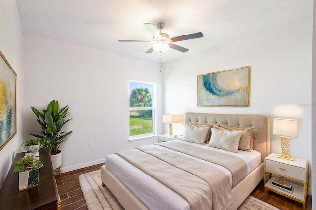 bedroom with ceiling fan and dark wood-type flooring