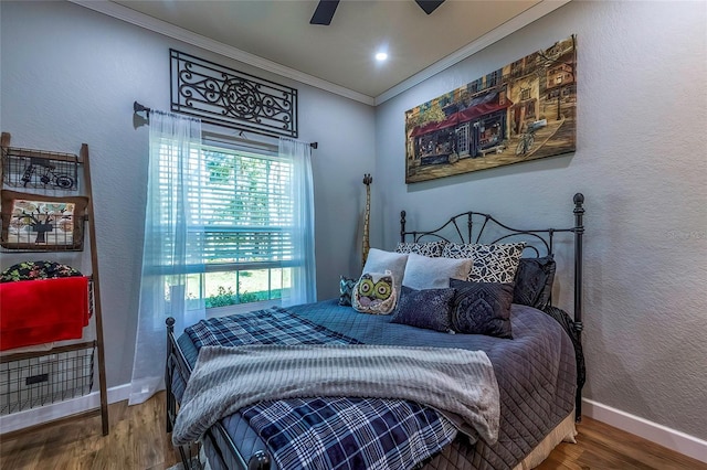 bedroom with hardwood / wood-style floors, ceiling fan, and crown molding