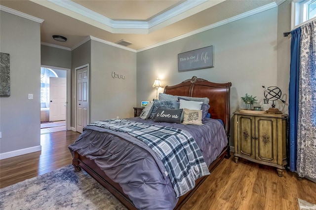 bedroom featuring wood-type flooring, a closet, and crown molding