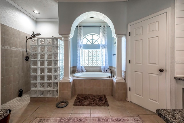 bathroom featuring shower with separate bathtub, a textured ceiling, decorative columns, and tile patterned floors