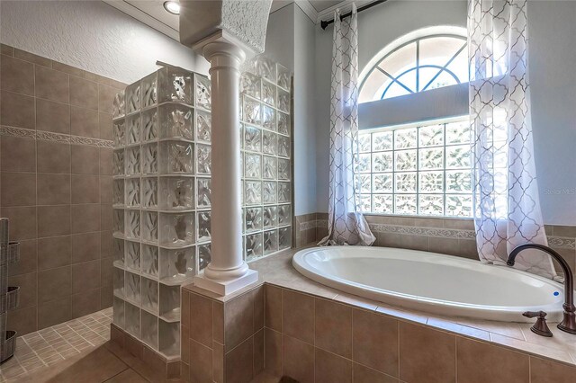 bathroom featuring shower with separate bathtub and ornate columns