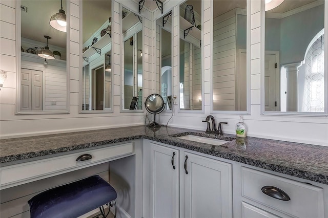 bathroom with vanity and ornamental molding