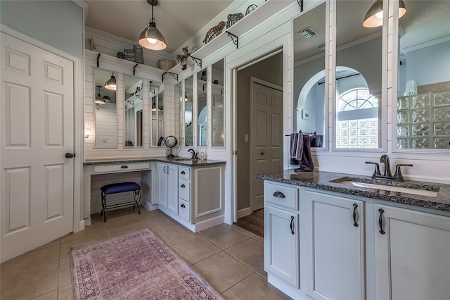 bathroom with tile patterned floors, crown molding, and vanity