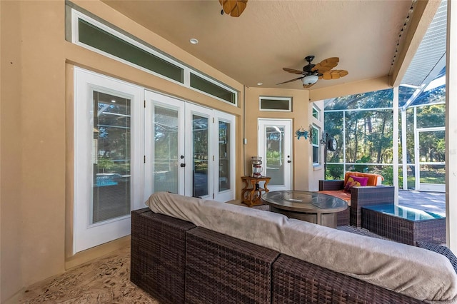 sunroom / solarium featuring ceiling fan and french doors