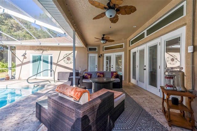 view of patio featuring glass enclosure, ceiling fan, an outdoor hangout area, and french doors