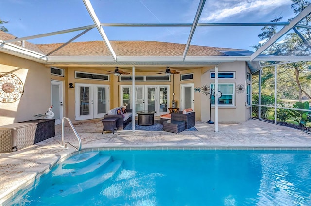 view of swimming pool with glass enclosure, a patio area, and french doors