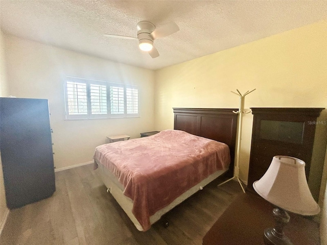 bedroom featuring ceiling fan, a textured ceiling, and pool table