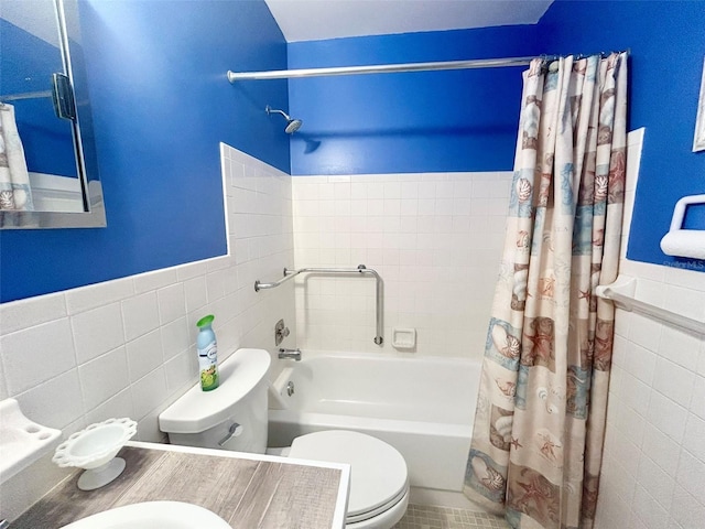 bathroom featuring shower / bath combo, toilet, and tile walls