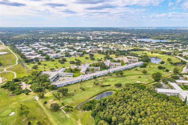 drone / aerial view featuring view of golf course and a water view