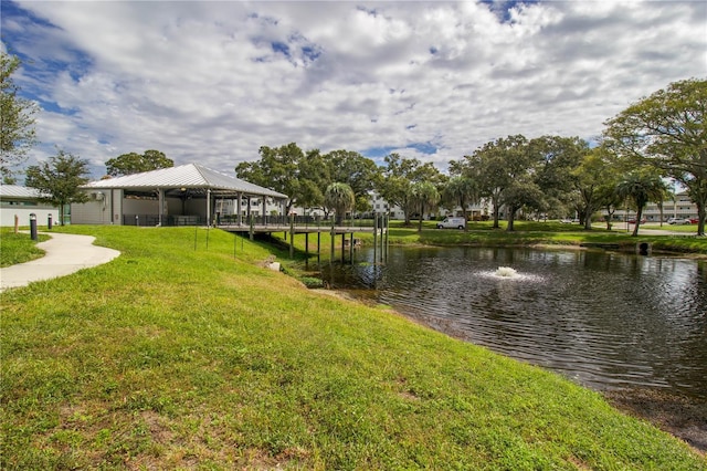 exterior space featuring a water view and a lawn