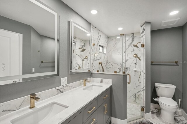 bathroom featuring vanity, toilet, and a shower with shower door