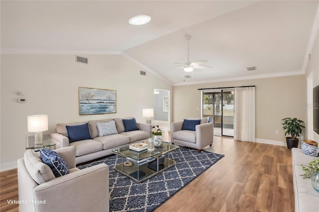 living room featuring hardwood / wood-style flooring, vaulted ceiling, ceiling fan, and crown molding