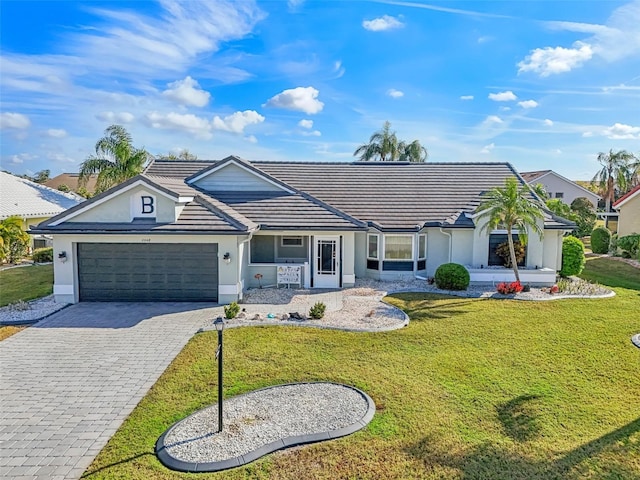 ranch-style home featuring a front yard and a garage