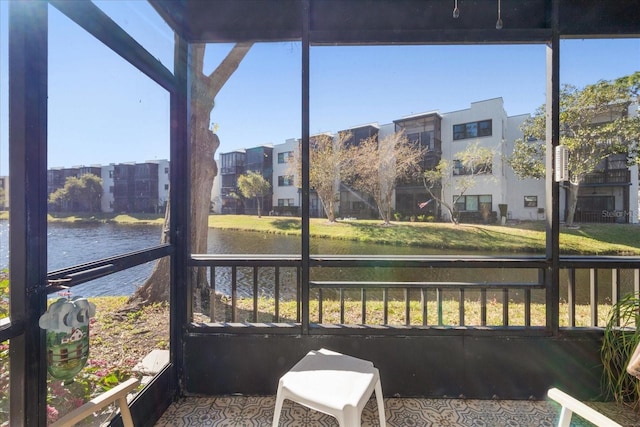 sunroom / solarium featuring a water view