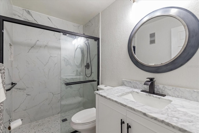 bathroom with vanity, toilet, and walk in shower