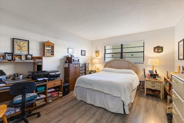 bedroom with a textured ceiling and hardwood / wood-style flooring