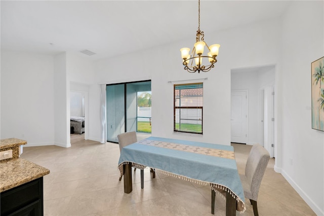 tiled dining space featuring a chandelier