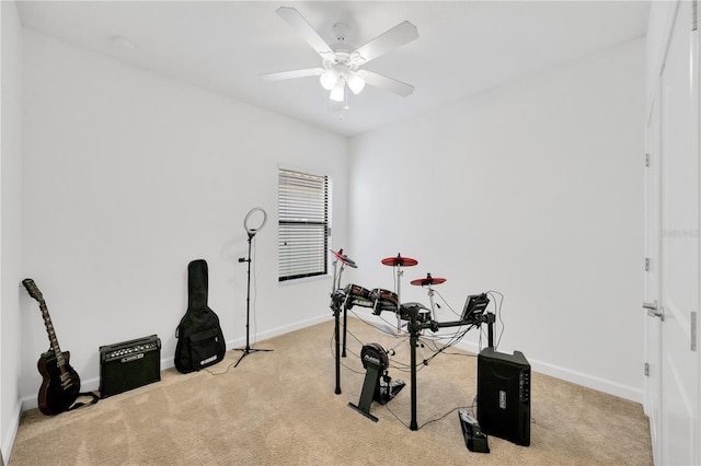 workout area featuring ceiling fan and light carpet