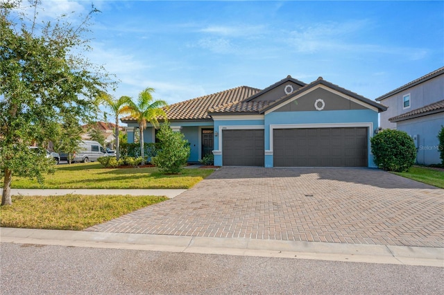 view of front of property with a garage and a front yard