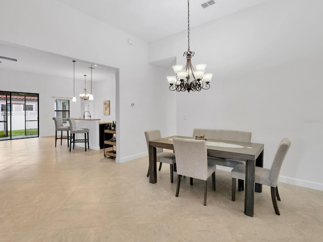 tiled dining area with a chandelier