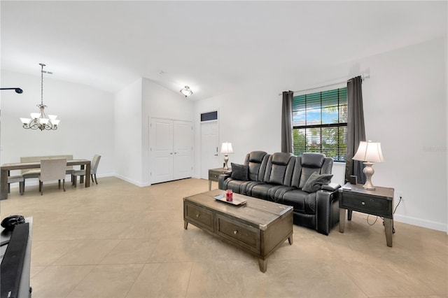 living room with a chandelier, light tile patterned floors, and vaulted ceiling