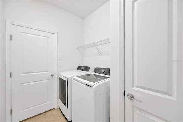 laundry room with light tile patterned floors and separate washer and dryer