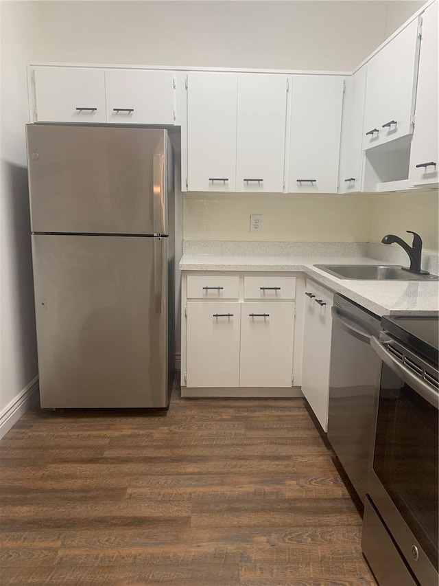 kitchen featuring white cabinets, stainless steel appliances, dark hardwood / wood-style floors, and sink