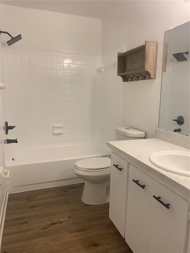 full bathroom featuring vanity, hardwood / wood-style flooring, toilet, and tub / shower combination