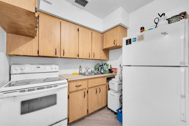 kitchen featuring white appliances, sink, light brown cabinetry, and light hardwood / wood-style flooring