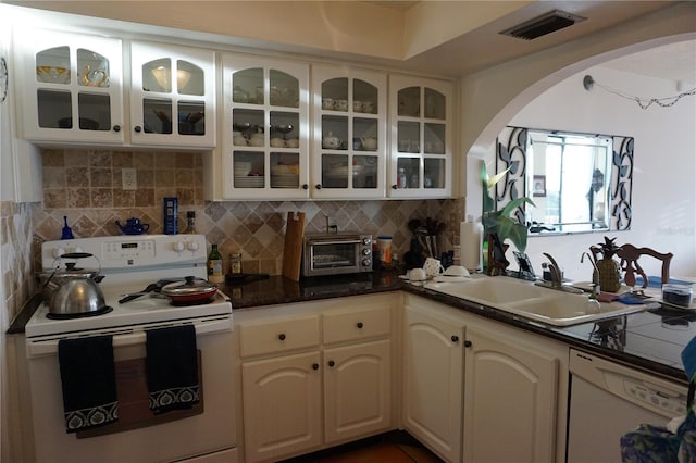 kitchen with backsplash, white cabinets, white appliances, and sink