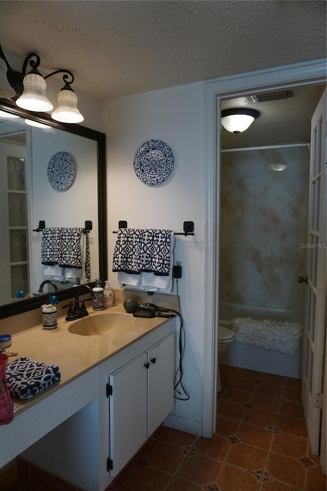 full bathroom with washtub / shower combination, vanity, a textured ceiling, and toilet