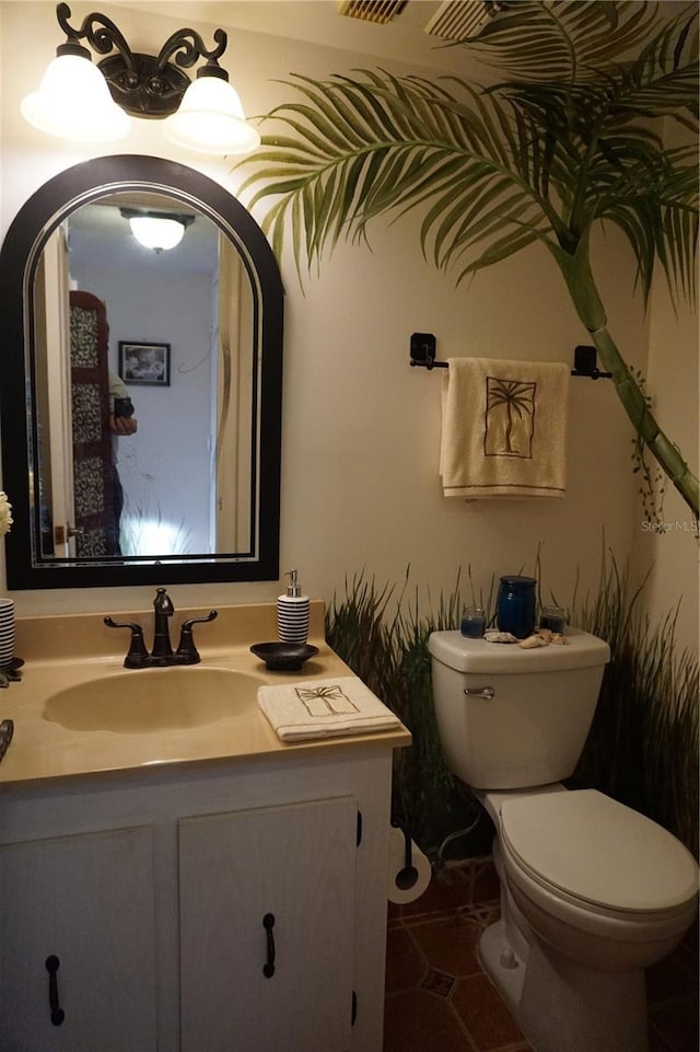 bathroom featuring tile patterned floors, vanity, and toilet