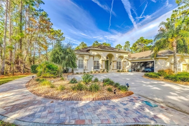 mediterranean / spanish-style house with a garage