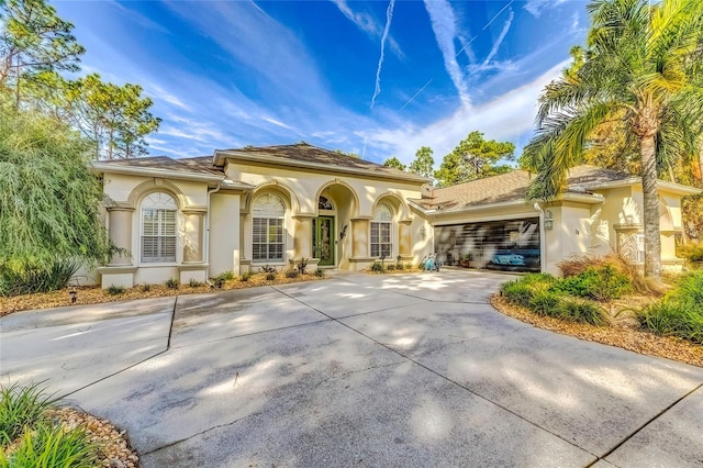 mediterranean / spanish-style home featuring a garage