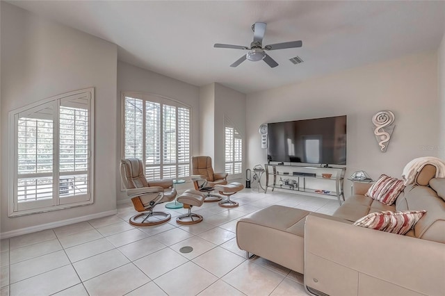 tiled living room with ceiling fan and a healthy amount of sunlight