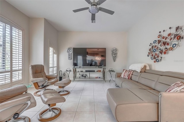 living room with ceiling fan, plenty of natural light, and light tile patterned floors