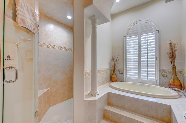 bathroom with a wealth of natural light and independent shower and bath