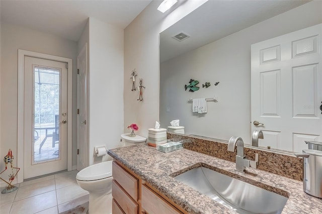 bathroom featuring tile patterned floors, vanity, and toilet