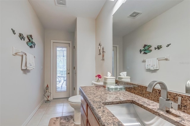 bathroom featuring tile patterned flooring, vanity, and toilet