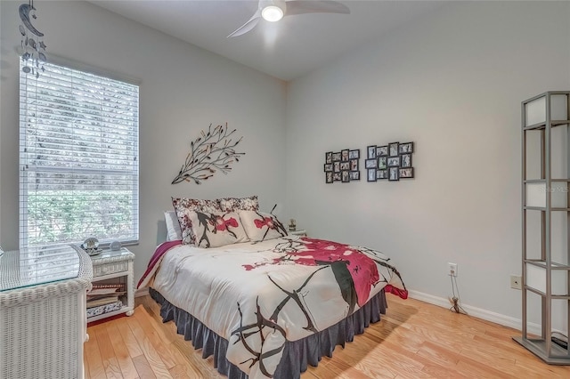 bedroom with light hardwood / wood-style flooring, multiple windows, and ceiling fan