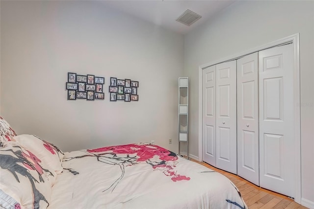 bedroom featuring light hardwood / wood-style flooring and a closet