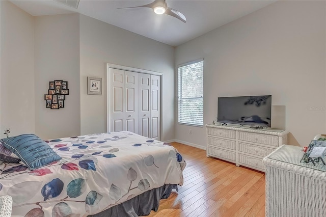 bedroom with ceiling fan, wood-type flooring, and a closet