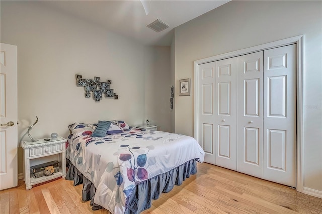 bedroom with ceiling fan, light wood-type flooring, and a closet