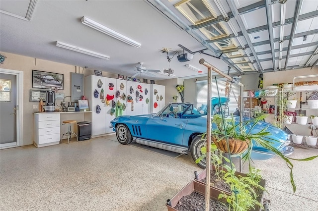 garage featuring a garage door opener and ceiling fan