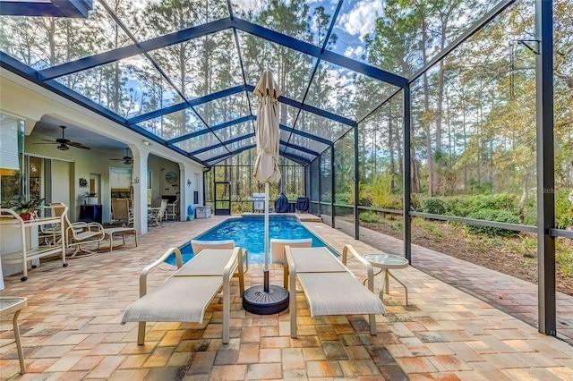 unfurnished sunroom featuring ceiling fan and a swimming pool